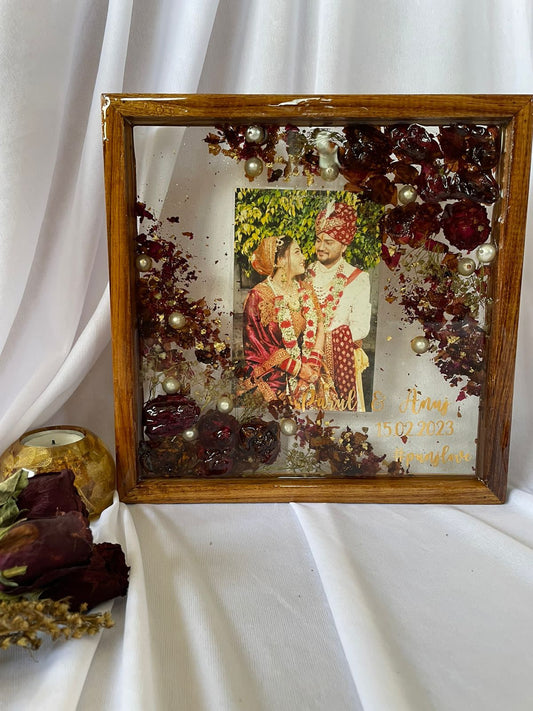 Everlasting Harmony: Preserved Wedding Flowers and Couples' Picture in a Wooden Frame