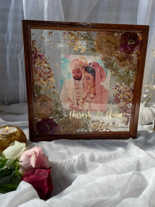 Endless Bliss: Wedding Varmala Preserved in Wooden Frame with Couples' Picture