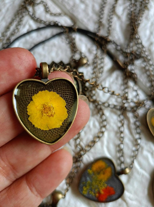 Resin Heart Shaped Pendant Yellow Flower Inclusion